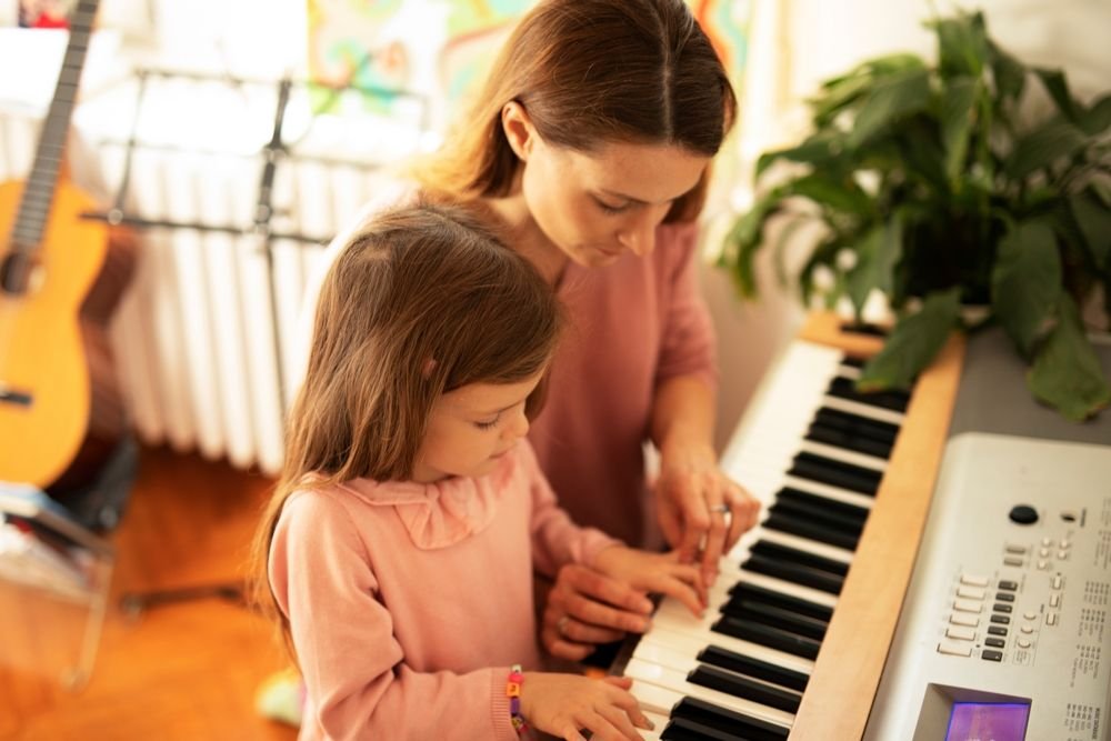 Woman,And,Girl,Playing,A,Piano.,Beautiful,Mom,Teaching,Her